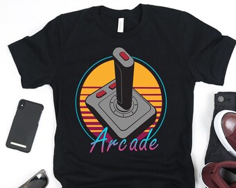 May include: Black t-shirt with a retro-style graphic of a joystick and the word "Arcade" in a colorful font.