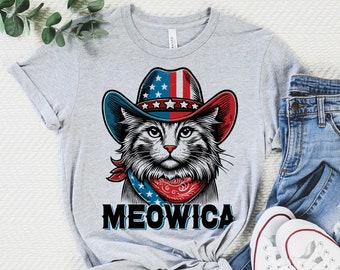 May include: A gray t-shirt with a graphic of a cat wearing a red, white, and blue cowboy hat and bandana. The text "MEOWICA" is printed below the cat.
