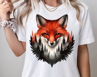 May include: White t-shirt with a graphic of a red fox in a forest setting. The fox is looking directly at the viewer. The graphic is in a vintage style.