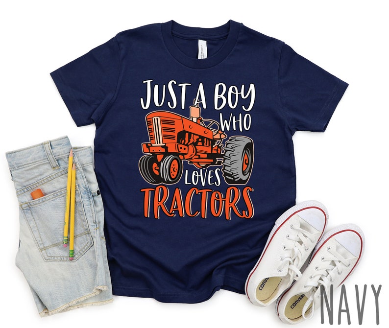 May include: A navy blue t-shirt with a red tractor graphic and the text "Just a boy who loves tractors".