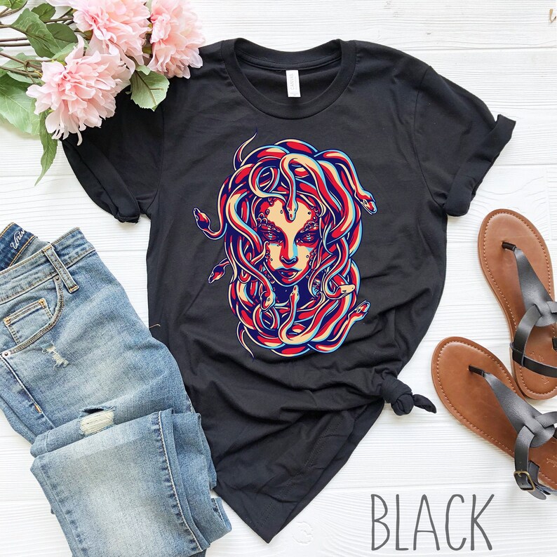 May include: Black t-shirt with a graphic print of Medusa, a mythical Greek figure with snakes for hair. The graphic is in a retro style with red, blue, and yellow colors.