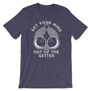 May include: A navy blue t-shirt with a white graphic of a bowling pin and two bowling balls with the text "Get Your Mind Out Of The Gutter".