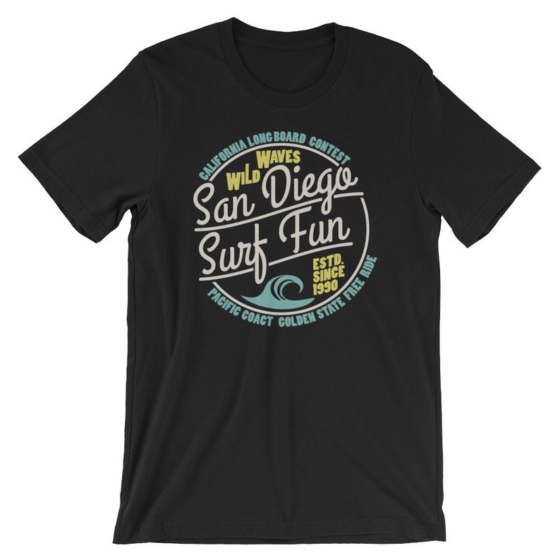 May include: Black t-shirt with a vintage-style graphic design featuring a circle with the text "California Longboard Contest Wild Waves San Diego Surf Fun Est. Since 1990 Pacific Coast Golden State Free Ride".