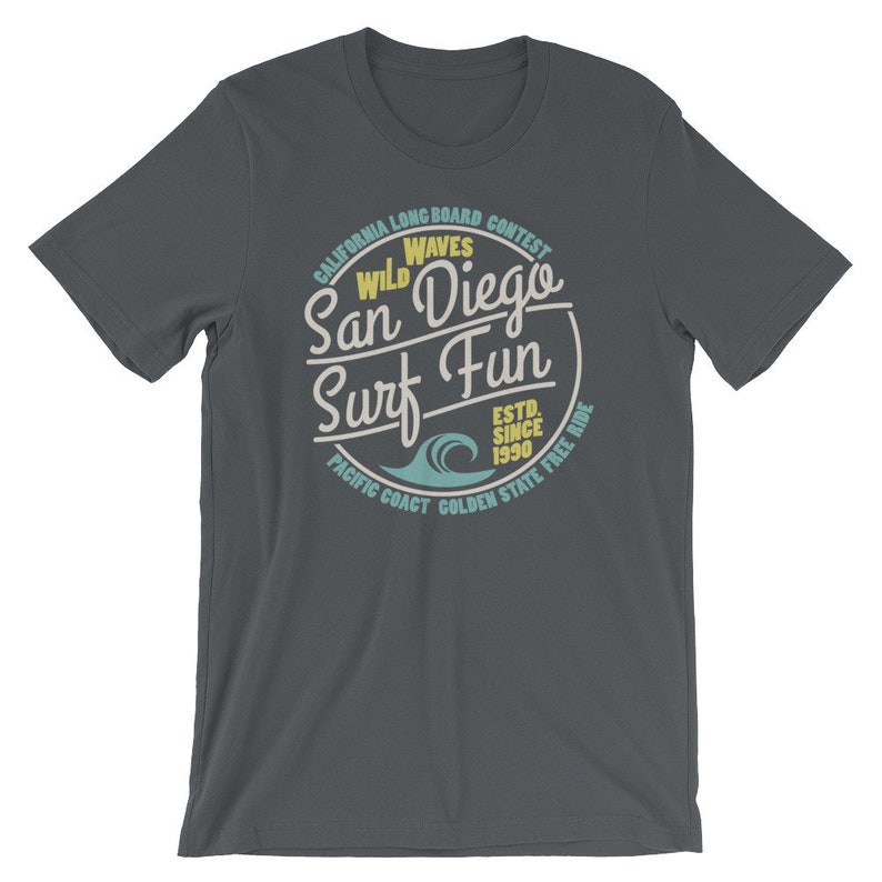 May include: Dark gray t-shirt with a vintage-style circular graphic that says "California Longboard Contest Wild Waves San Diego Surf Fun Est. Since 1990 Pacific Coast Golden State Free Ride".