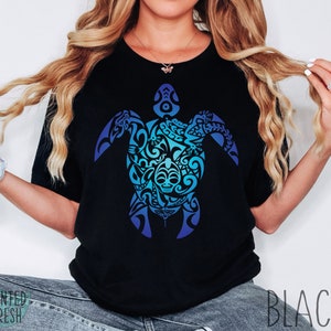 May include: A black t-shirt with a blue and green gradient design of a stylized turtle with intricate patterns. The design is centered on the shirt.