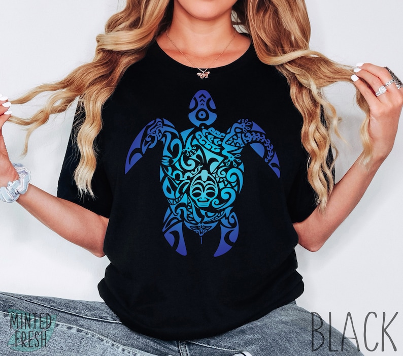 May include: A black t-shirt with a blue and green gradient design of a stylized turtle with intricate patterns. The design is centered on the shirt.