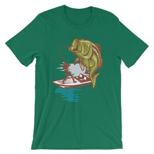 May include: A green t-shirt with a graphic of a fisherman in a boat reeling in a large bass.