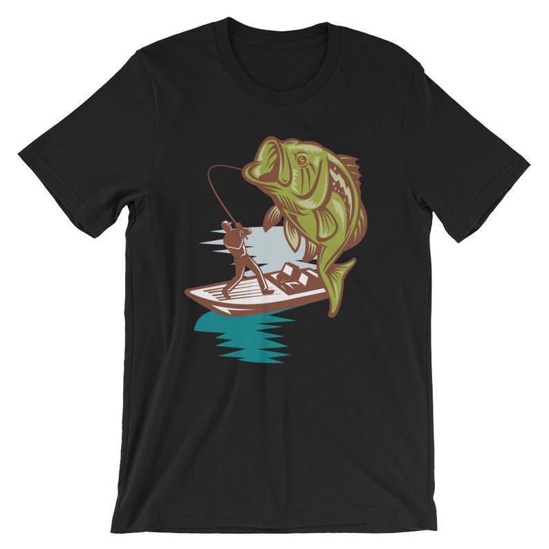 May include: A black t-shirt with a graphic of a person fishing from a boat with a large bass jumping out of the water.