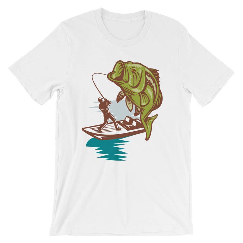 May include: A white t-shirt with a graphic of a fisherman in a boat reeling in a large green bass.