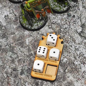May include: A wooden game tracker with five white dice. The dice are labeled "Turn", "Command Points", and "Victory Points".