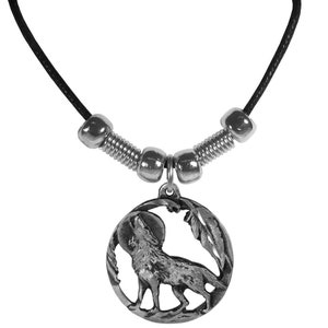 May include: A silver necklace with a round pendant featuring a wolf howling at the moon. The pendant is surrounded by a decorative border of leaves and feathers. The necklace is made of black cord with silver beads.