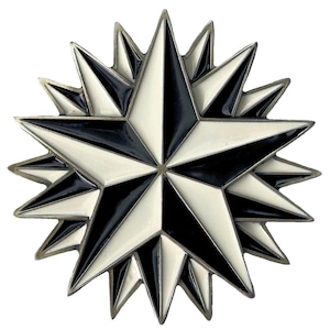 May include: A multi-pointed star emblem featuring alternating black and white enamel segments. The design consists of a large central star layered over a slightly offset secondary star, creating a complex geometric pattern with metallic silver-toned edges.
