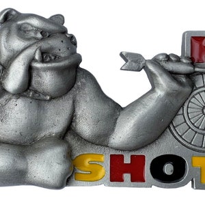 May include: A pewter bulldog figurine holding a dart in its hand, aiming at a dartboard with the letter "H" on it. The bulldog is wearing a collar and the words "SHOT" are written below the dartboard in yellow, red, black, and yellow letters.