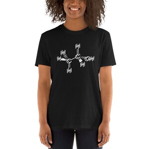 May include: A black t-shirt with a white chemical structure printed on the front. The structure is a representation of a molecule with carbon, hydrogen, and oxygen atoms.