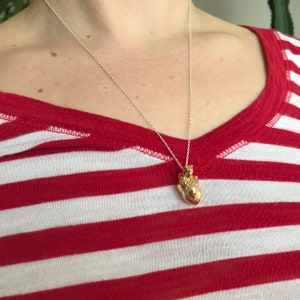 Woman wearing a real anatomical heart model necklace