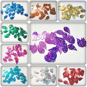 May include: Assortment of leaf-shaped sequins in various colors, including blue, green, purple, pink, gold, silver, and red. The sequins are iridescent and have a shiny finish.