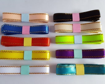 May include: Ten spools of satin ribbon with gold trim. The ribbons are in the colors peach, blue, black, cream, red, lime green, yellow, purple, white, and teal.