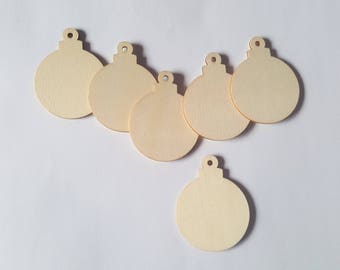 May include: Six unfinished wooden ornaments shaped like Christmas tree baubles. The ornaments are all the same size and have a hole at the top for hanging.