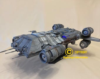 May include: A detailed model of a gray and white spaceship with multiple engines and a black base. The model is on a white background. COPYRIGHT BigBangCollectibles.