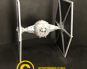 May include: A white and black TIE fighter model with a detailed cockpit and wings. The model is on a black background. COPYRIGHT BIGBANGCOLLECTABLES ON ETSY