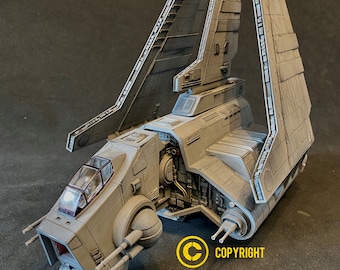 May include: A gray, detailed model of a Star Wars TIE bomber with a cockpit and two large wings. The model is on a gray surface. COPYRIGHT BigBangCollectibles.