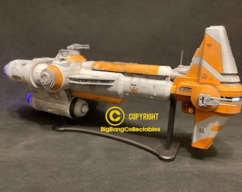May include: A detailed model of a Star Wars Republic Cruiser, painted in orange, white, and gray with a black stand. The model has a detailed cockpit and engine nacelles. The model is lit with blue lights. The model is on a black stand with the text "COPYRIGHT BigBangCollectables".