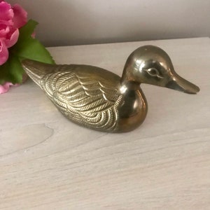 Brass bird sculpture.