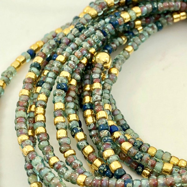 Seafoam: Light greens dotted with gold on a glass seed bead bracelet