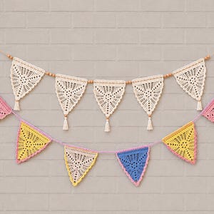 May include: Two layered crochet bunting garlands featuring triangular pennants. The top row has cream-colored lace triangles with small tassels and wooden beads. The bottom row features multicolored triangles in pink, yellow, and blue with pink trim.