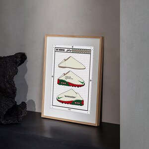May include: Framed print featuring three stylized illustrations of sneakers. The print includes the text "AIR MEDINA" and "MARRAKESH". The sneakers are depicted in white, red, and green, with a grid background and a wooden frame.