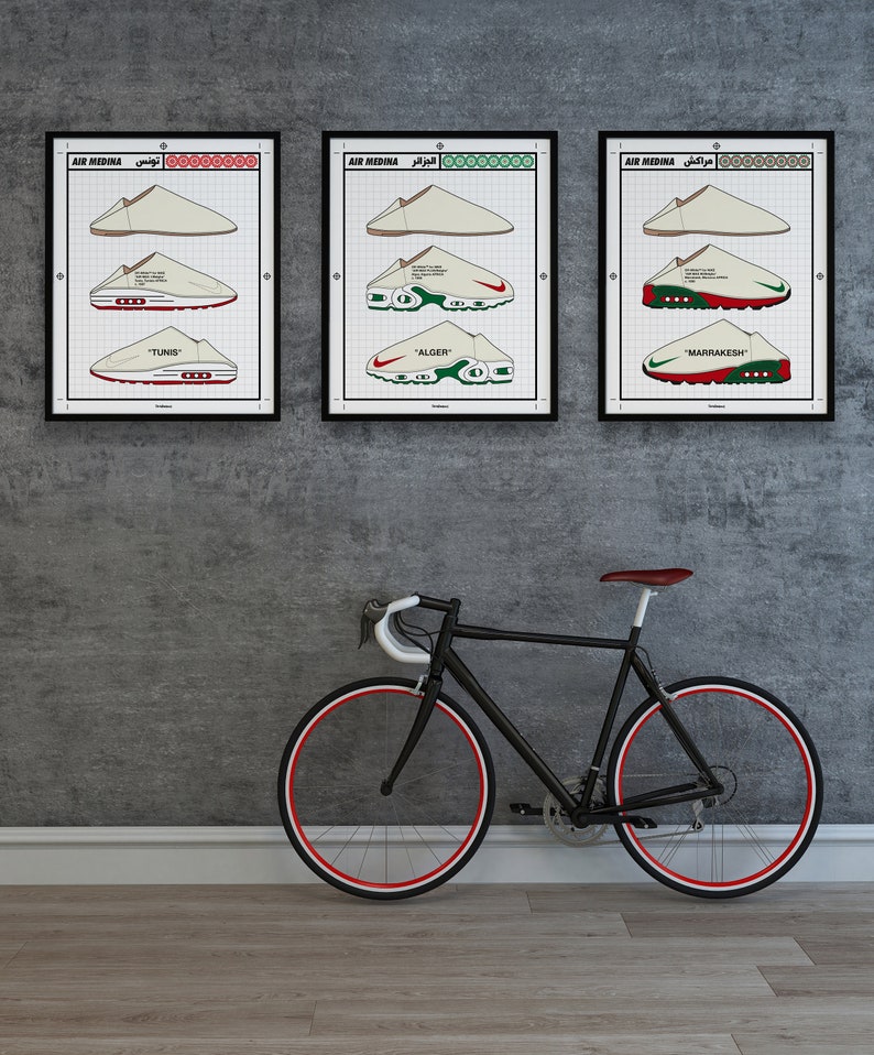 May include: Three framed prints featuring sneaker designs labeled "TUNIS", "ALGER", and "MARRAKESH" in a grid pattern. A black bicycle with red-lined wheels leans against a gray wall, complementing the artwork's color scheme.