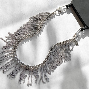 Close-up of flat curb chain with cascading fringe detail