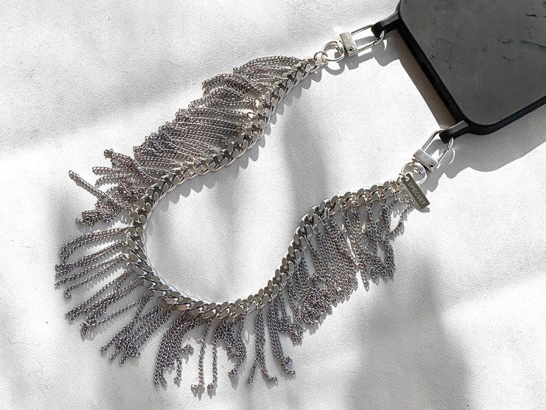 Close-up of flat curb chain with cascading fringe detail