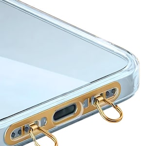 Ultra-thin stainless steel phone hanger in gold finish clipped inside a clear phone case.
