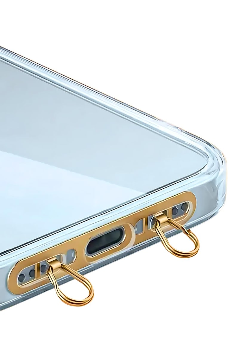 Ultra-thin stainless steel phone hanger in gold finish clipped inside a clear phone case.