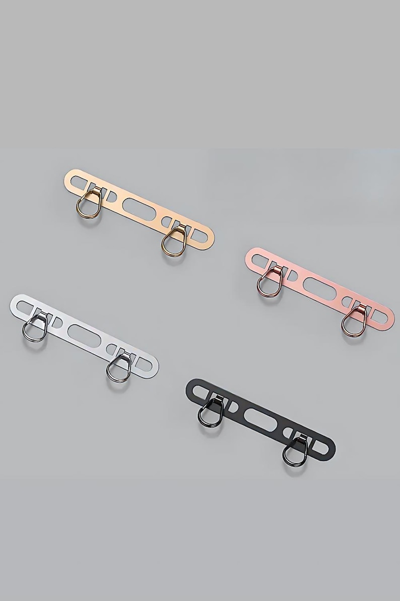 Flat lay of phone hanger accessory available in silver, gold, rose-gold, and black.