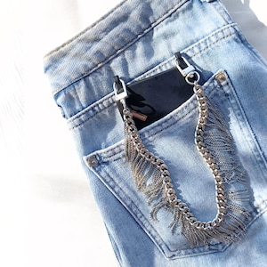 Silver fringe chain phone strap attached to black phone case