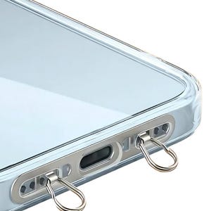 Ultra-thin stainless steel phone hanger in silver finish clipped inside a clear phone case.