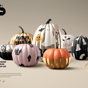 May include: A set of five Halloween pumpkins with different designs. The pumpkins are painted in various colors, including gold, silver, black, white, and pink. Some of the pumpkins have spooky designs, such as ghosts, bats, and skulls. Others have festive messages, such as "Happy Hallo" and "Focus".