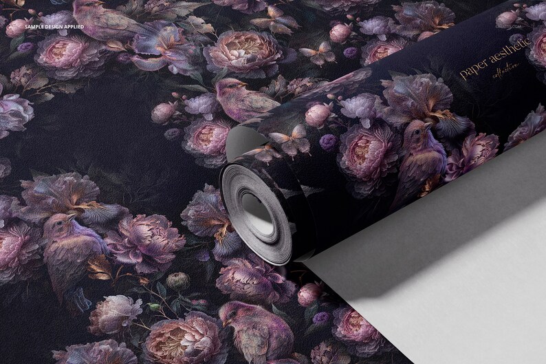 May include: A roll of dark purple floral wallpaper with a repeating pattern of birds, flowers, and butterflies. The wallpaper is rolled up and the label reads "paper aesthetic".