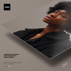 May include: A mockup of an aluminium print with sharp corners, featuring a person wearing a black jacket. The image includes the text "CLOSEUP OF ALUMINUM PRINT MOCKUP SET - SHARP CORNERS" and the "creatsy" logo.