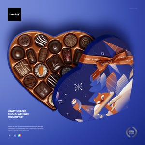 May include: A heart-shaped chocolate box mockup set, open to reveal an assortment of chocolates. The box is blue with a winter forest design and a brown ribbon. The text "Winter Forest" is visible on the ribbon.