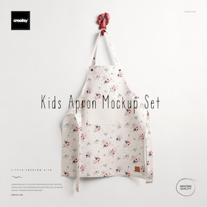Puede incluir: Un delantal blanco para niños con un estampado floral de flores rojas, azules y amarillas. El delantal tiene un bolsillo y está colgado de un gancho rojo. El texto "Kids Apron Mockup Set" se muestra en el delantal.