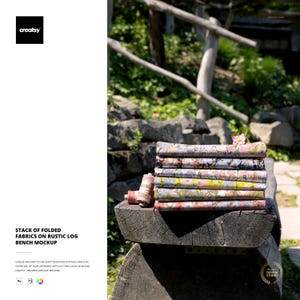 May include: A stack of folded fabrics with floral patterns rests on a rustic wooden bench. The fabrics display various colors, including pink, yellow, and blue. A spool of thread sits beside the stack. The image includes the text "STACK OF FOLDED FABRICS ON RUSTIC LOG BENCH MOCKUP."