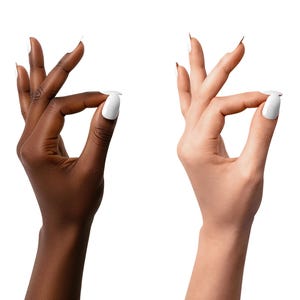 May include: Two hands, one dark and one light, each making an 'okay' sign with white nail polish. The image is on a white background, with the text "TWO SKIN TONES" in the upper left corner. The nails are long and pointed.