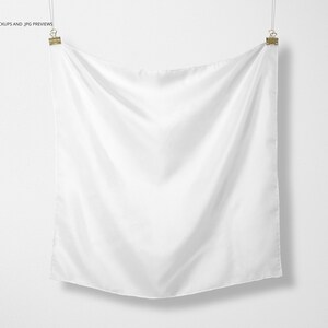 May include: A white fabric square hanging from two clips against a white background.