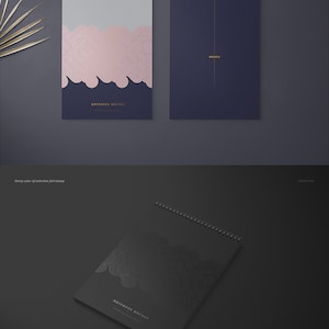 May include: A mockup of a spiral bound notebook with a black cover and a geometric pattern in a silver foil finish. The text "NOTEBOOK MOCKUP" is printed on the cover.