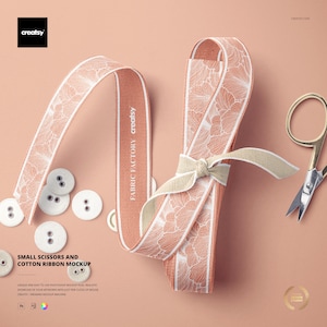 May include: A mockup featuring a peach-colored ribbon with a white floral pattern, tied with a beige bow. Small gold scissors and white buttons are also present. The text "SMALL SCISSORS AND COTTON RIBBON MOCKUP" is visible.