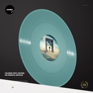May include: A teal vinyl record featuring the text "DAY DREAMING" on the label. The record is presented on a pedestal mockup against a black backdrop. The record has a diameter of approximately 30 cm.