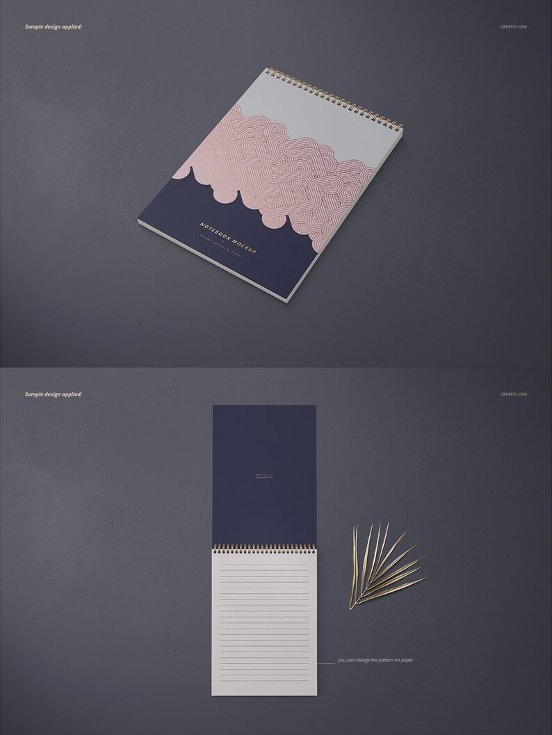 May include: A mockup of a spiral bound notebook with a navy blue cover and a pink and gold geometric pattern. The notebook is lying flat on a gray surface. The text "NOTEBOOK MOCKUP" is printed on the cover.